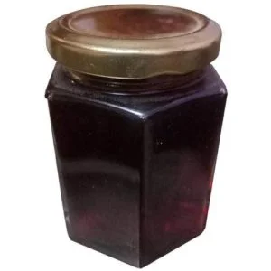 Hexagonal glass jar with a gold lid from DM Traders Organic Store.