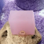 Pink Lavender Soap Bar From Dm Traders Organic Store, Placed On A Wooden Surface With Purple Crystals In The Background.