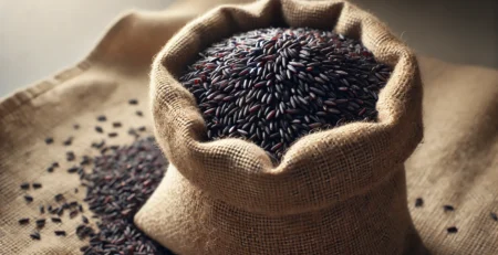 A realistic wide-aspect ratio image of Karuppu Kavuni Rice benefits in a sack bag. The sack is open, revealing the deep black rice grains.